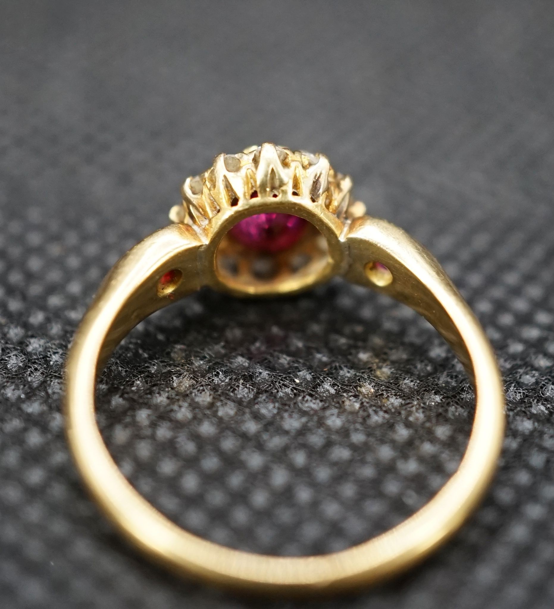 A late Victorian 18ct gold ruby and diamond cluster ring, with ruby set shoulders, size M, gross weight 2.7 grams.